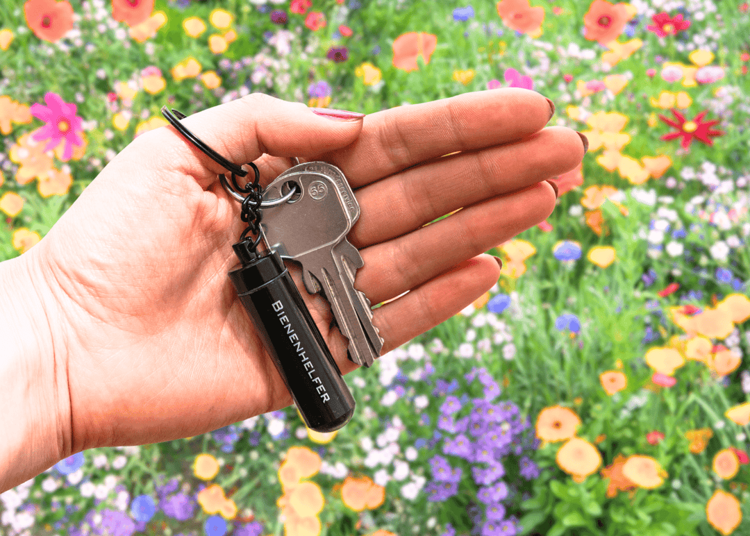 Bienenhelfer am Schlüsselbund vor Blumenwiese